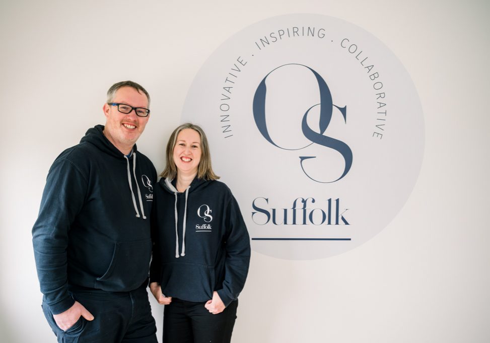 man and women learning on wall with OS Suffolk logo